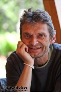 Hjorliefur Jonsson wearing dark gray shirt smiling into camera