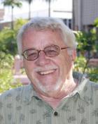 Ralph Gabbard wearing glasses smiling into camera